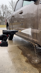 TorqueWash washing the side of a car in the driveway